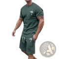 Dark green tropical palm tree short sleeve athletic set with white embroidery featuring a tee and matching shorts