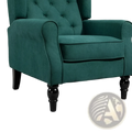 Emerald green tufted velvet accent chair with black turned wooden legs for stylish and comfortable seating