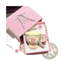 Pastel yellow ceramic tulip mug with pink floral design and flower-shaped handle in matching pink gift box