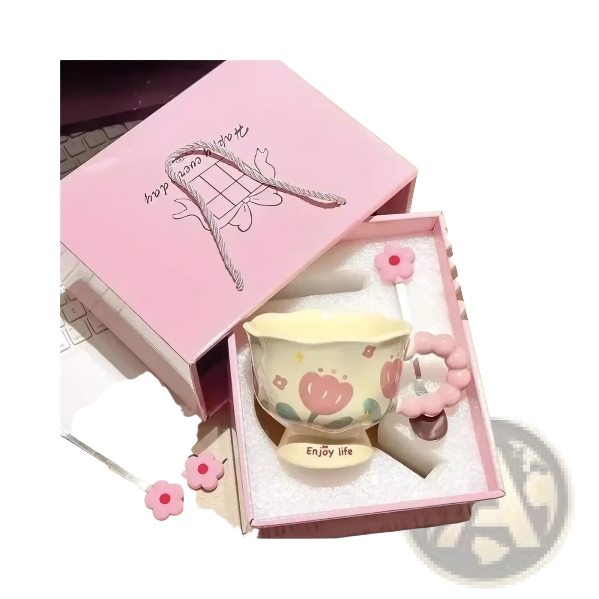 Pastel yellow ceramic tulip mug with pink floral design and flower-shaped handle in matching pink gift box