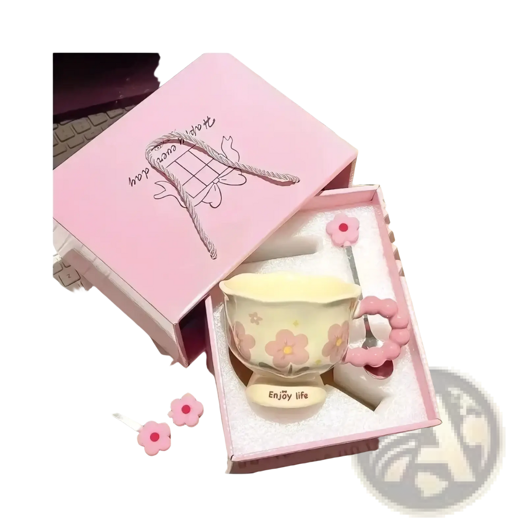 Pastel pink tulip ceramic mug with floral design and matching flower-shaped handle nestled in a gift box