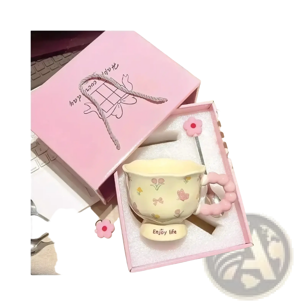Pastel yellow ceramic tulip mug with pink floral and butterfly decals and a matching pink beaded handle in gift box