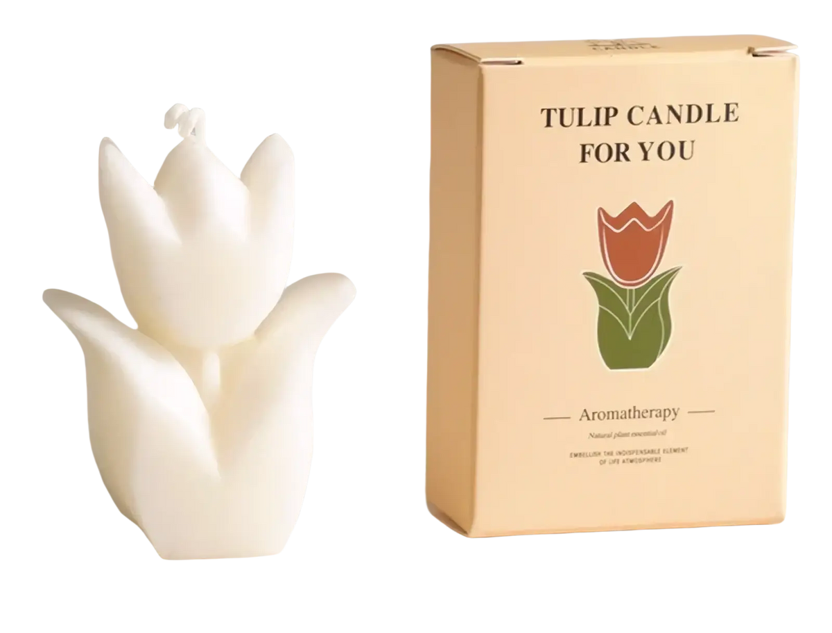 A white sculpted tulip-shaped scented candle with wick for aesthetic room decor