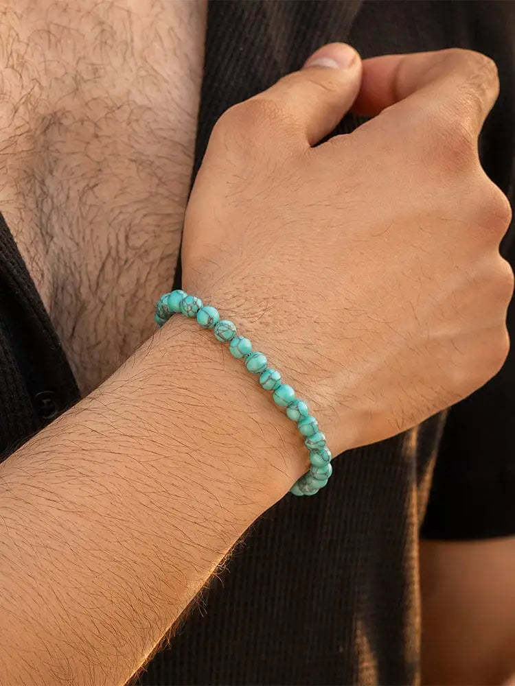 Handcrafted Bali turquoise stone beaded bracelet with natural texture and silver clasp worn on a wrist