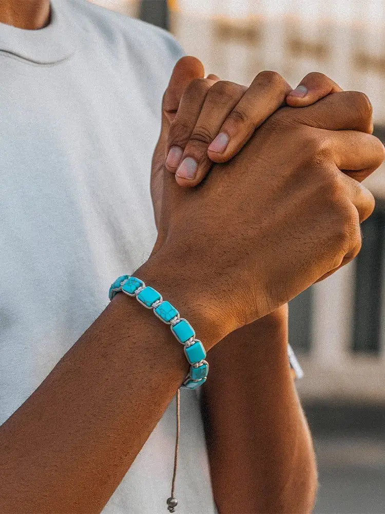 A turquoise rectangular stone bracelet with silver-toned accents worn on wrist from Havana Authentic Turquoise Beaded Macrame Bracelet