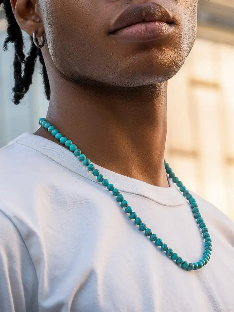 Adjustable turquoise bead necklace featuring smooth round turquoise stones in stainless steel settings