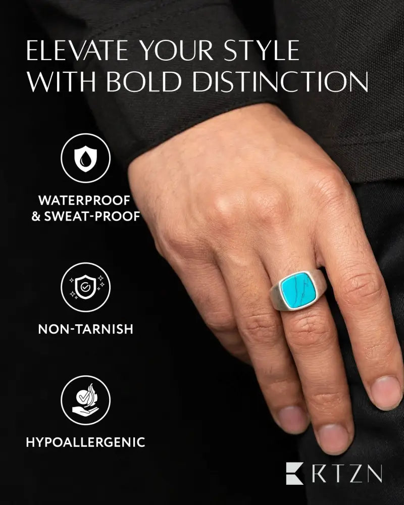 A sleek silver-toned stainless steel oxidized turquoise cushion signet ring with a vibrant square stone in minimalist design