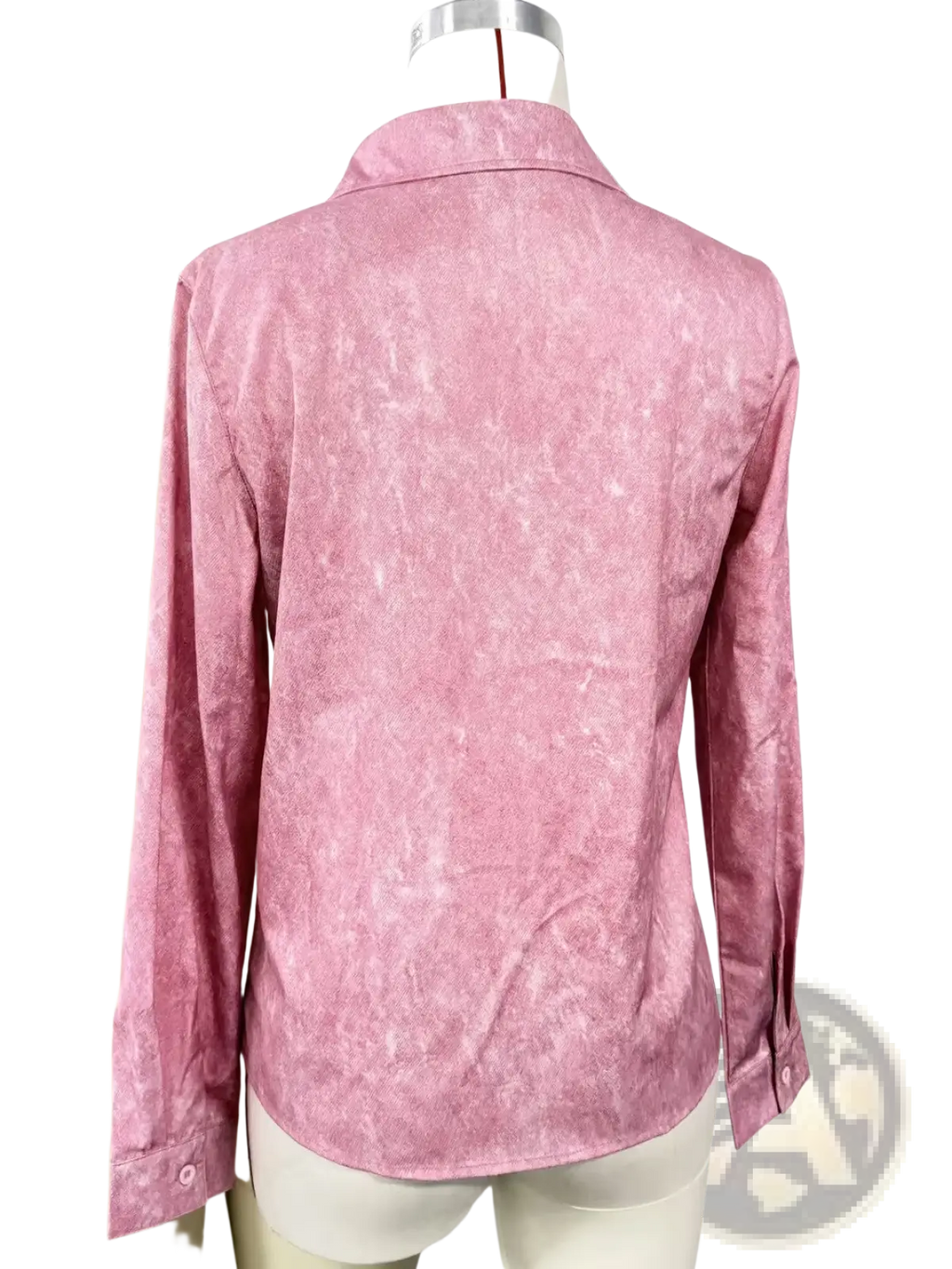A soft pink long-sleeved button-up shirt with a subtle texture displayed on a mannequin for casual wear