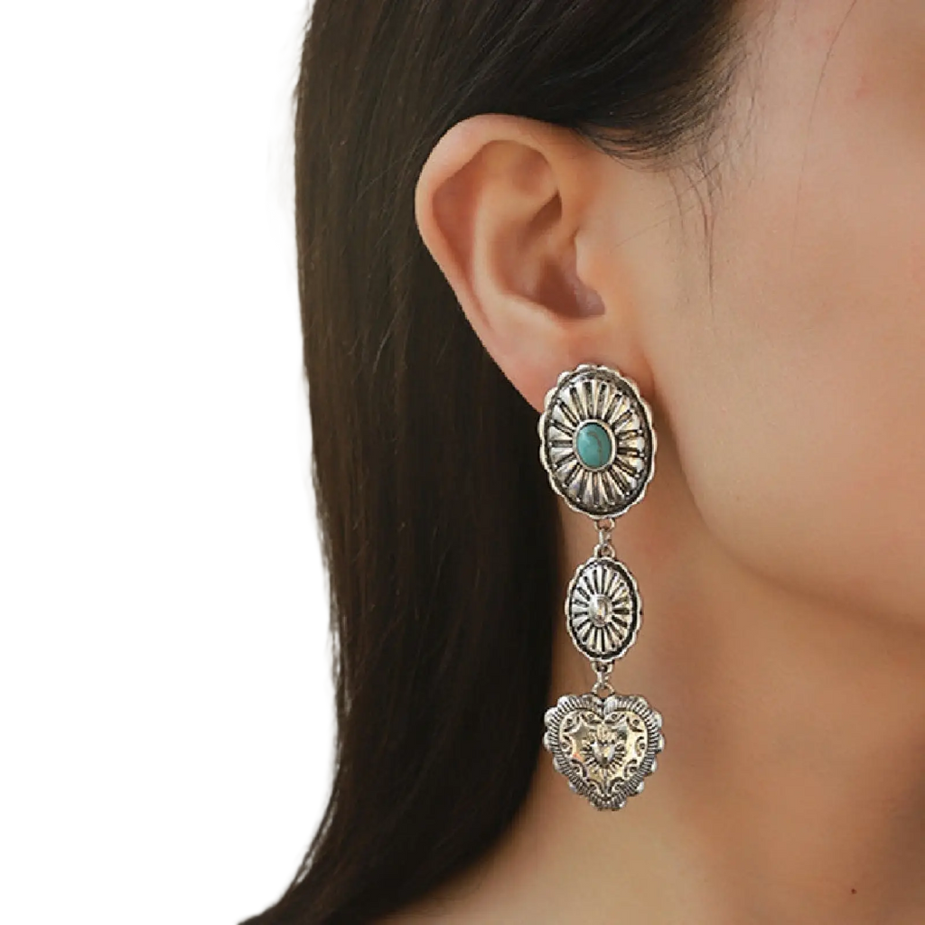 Silver-toned dangle earring with turquoise oval stone and heart-shaped pendant from turquoise heart and sunburst set