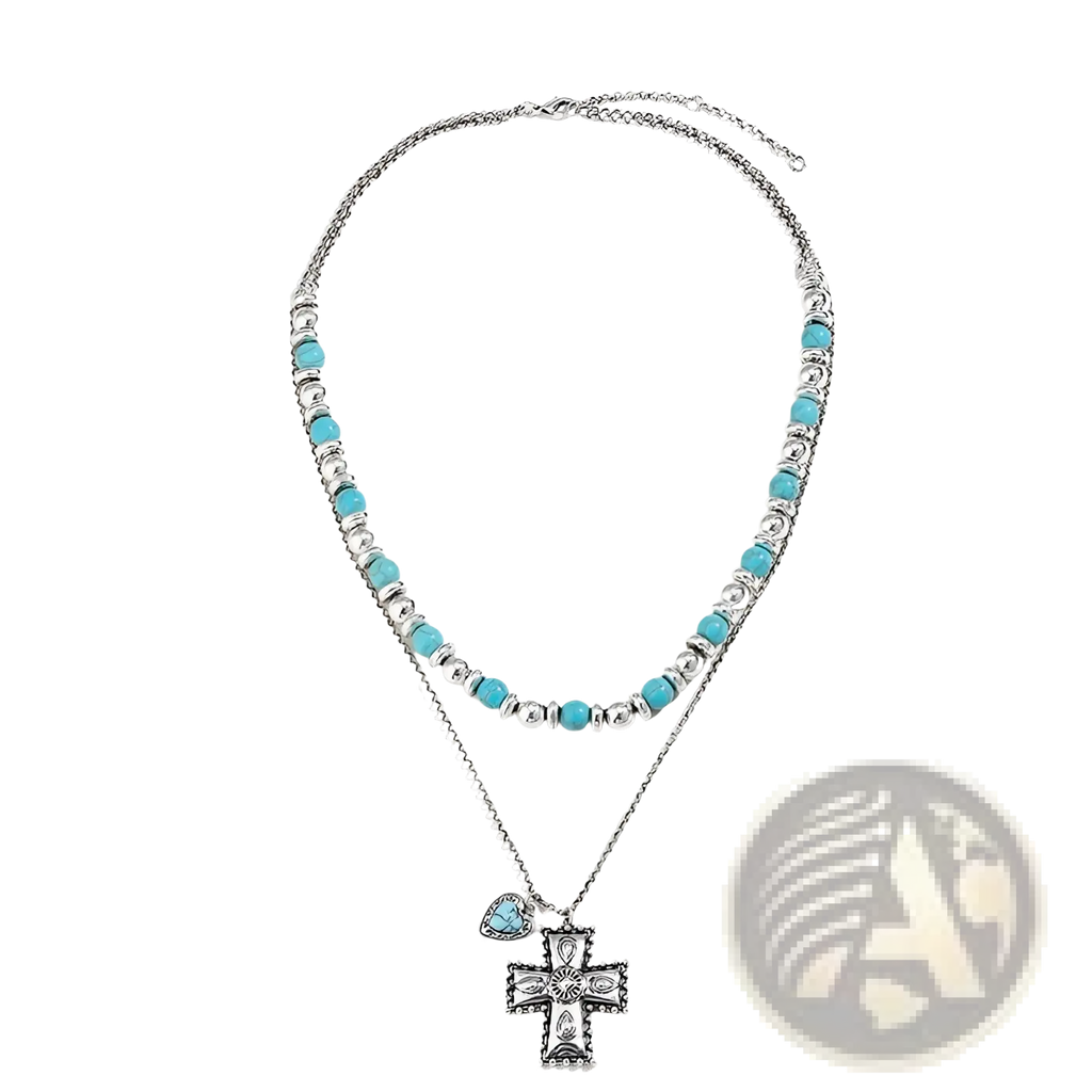 A two-layered turquoise and silver necklace with intricate cross pendant from the turquoise heart and sunburst set