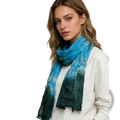 A turquoise metallic skinny scarf with a flowing blue-to-green gradient and subtle gold-trimmed horizontal bands