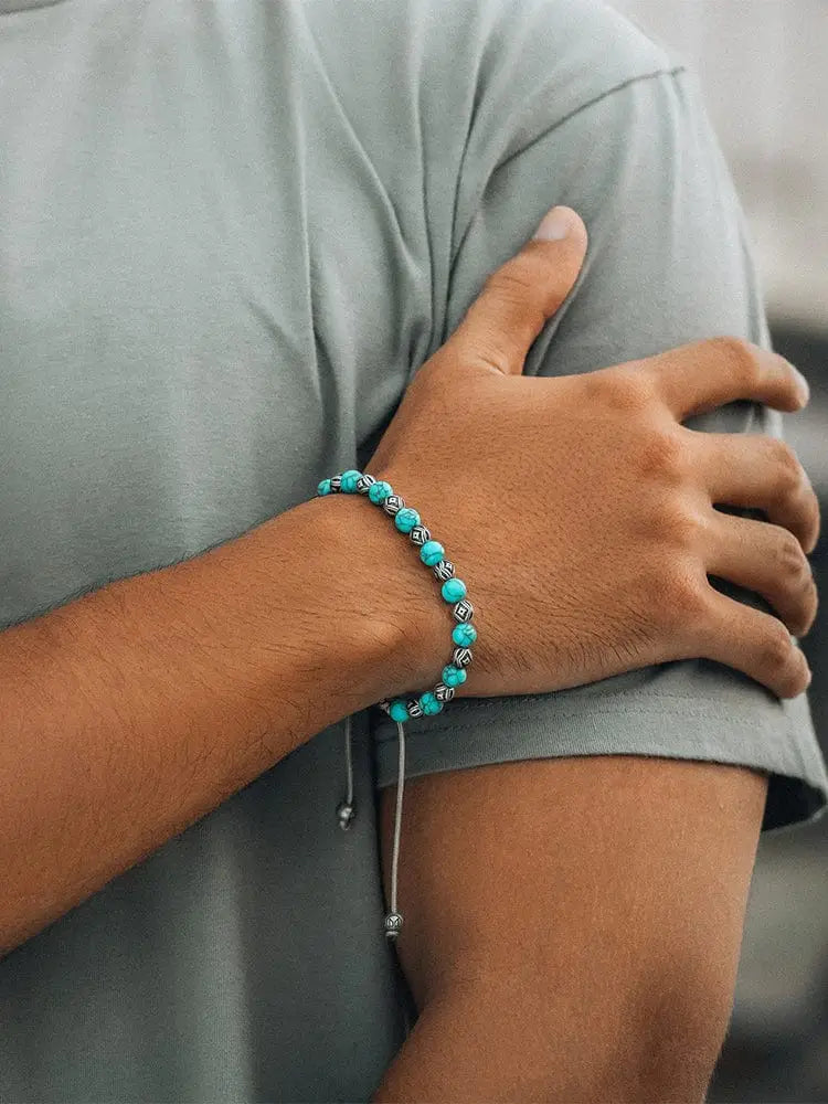 Native turquoise and silver beaded bracelet with toggle clasp and silver-toned accents worn on a wrist