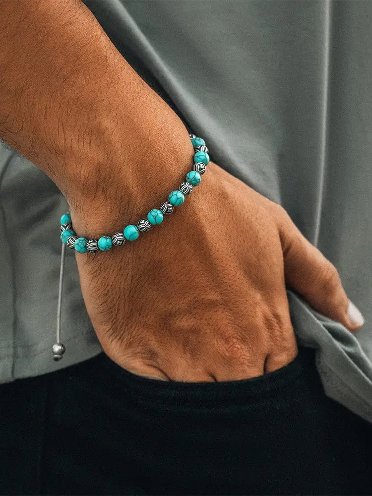 Native turquoise and silver beaded bracelet with intricate geometric designs and a toggle clasp closure