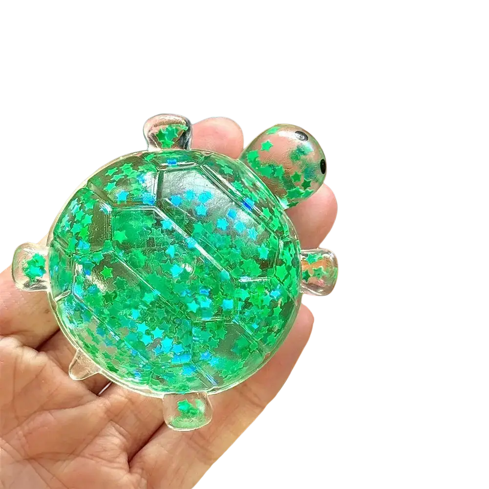 A translucent green turtle toy fidget toy stress ball filled with sparkling star confetti for soft squeeze relief