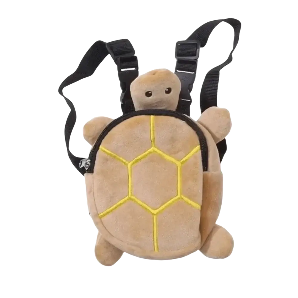 Plush tan turtle shape dog backpack with yellow stitched shell patterns and black adjustable straps for pet carrying