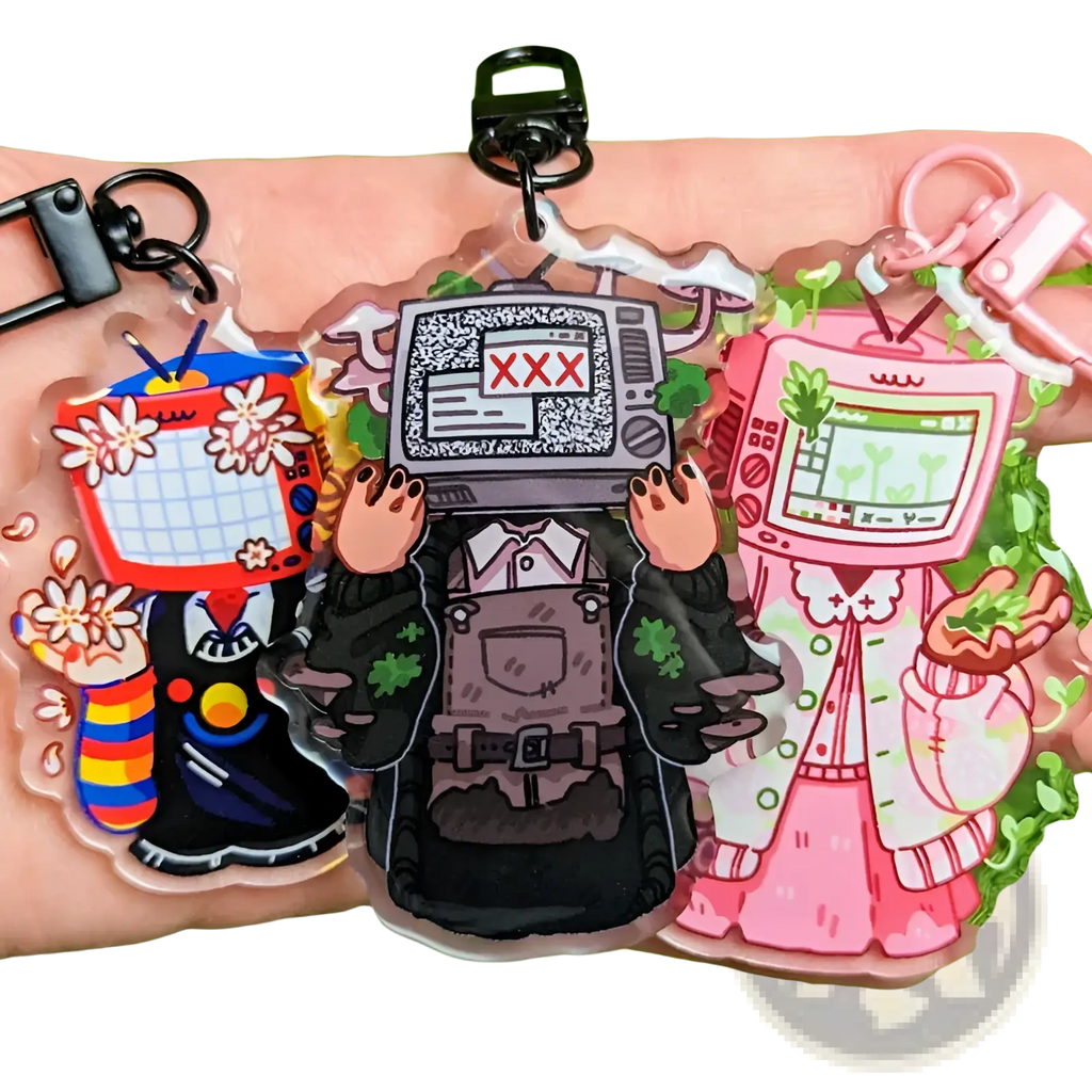 Three colorful transparent acrylic tv head anime keychains in retro video game style as customizable bag charms