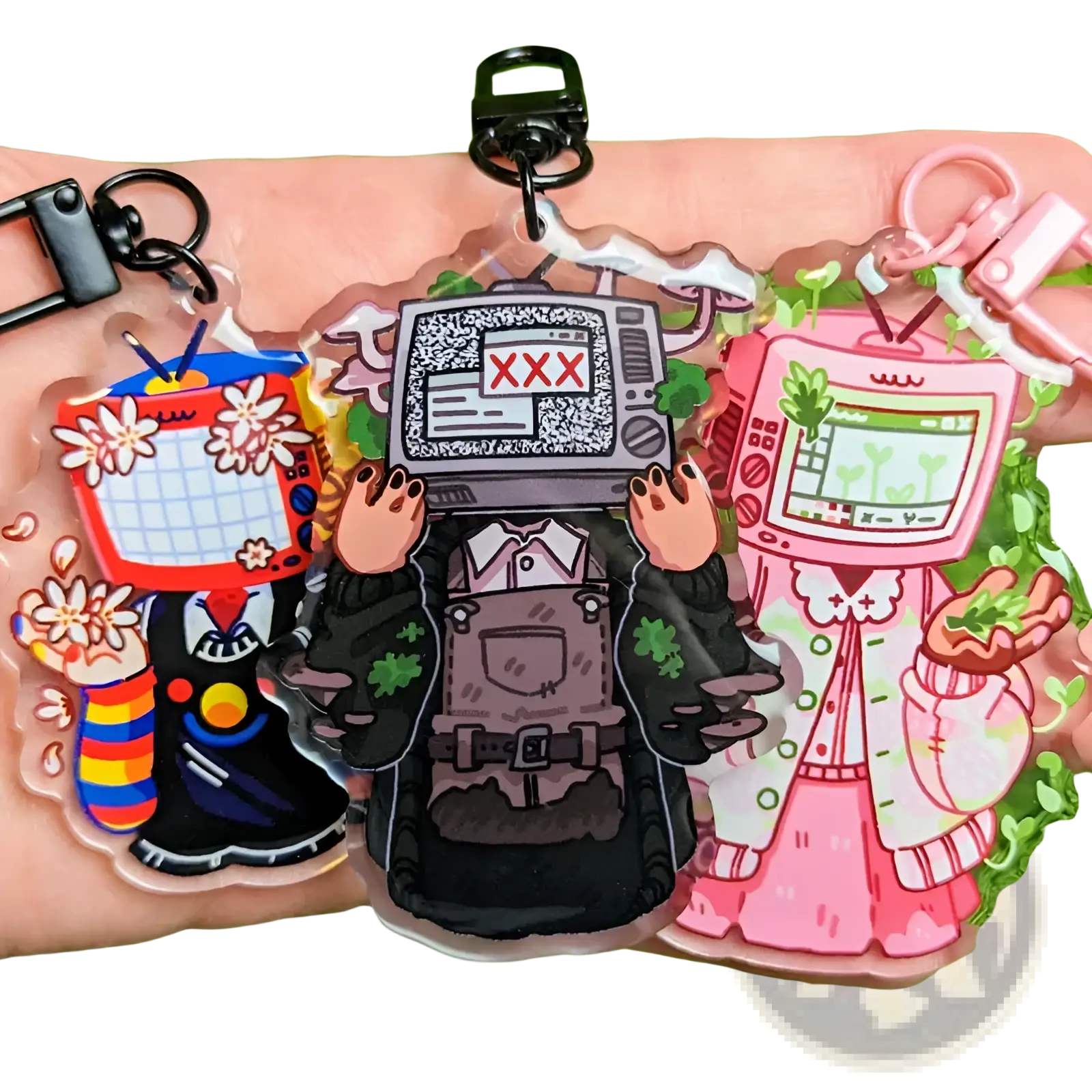 Three colorful transparent acrylic tv head anime keychains in retro video game style as customizable bag charms