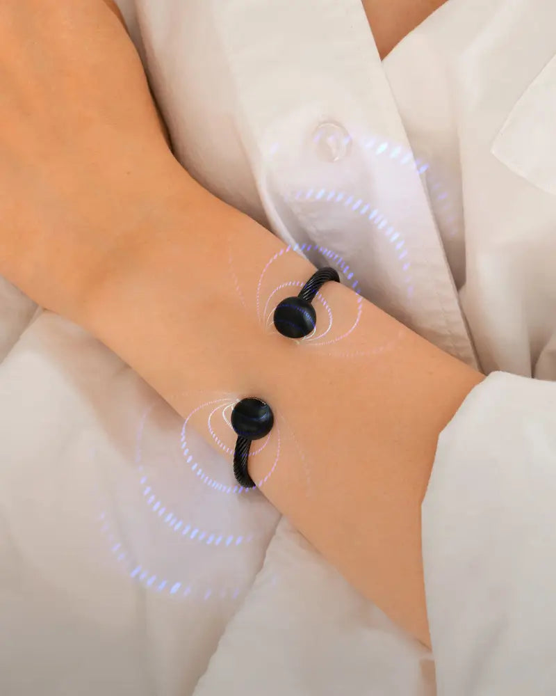 Black twisted cable magnetic bracelet with spherical ends worn on wrist showcasing sleek modern design