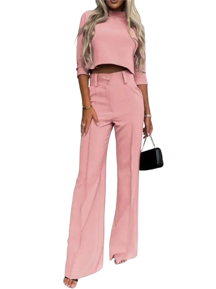 A soft pink two piece office suit with a cropped top with three quarter sleeves and high waisted wide leg pants