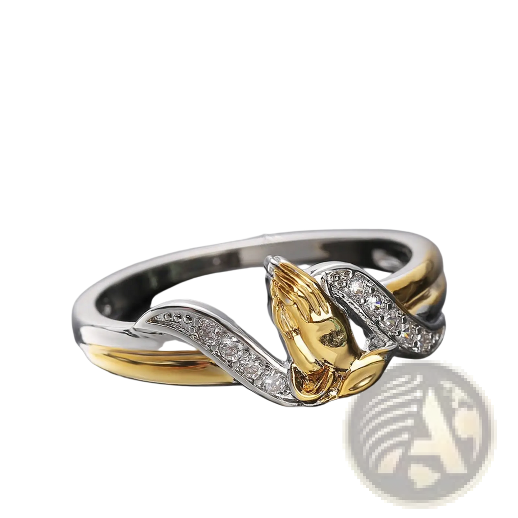 Two tone 18k gold and silver ring with a central praying hands design adorned with clear cubic zirconia stones