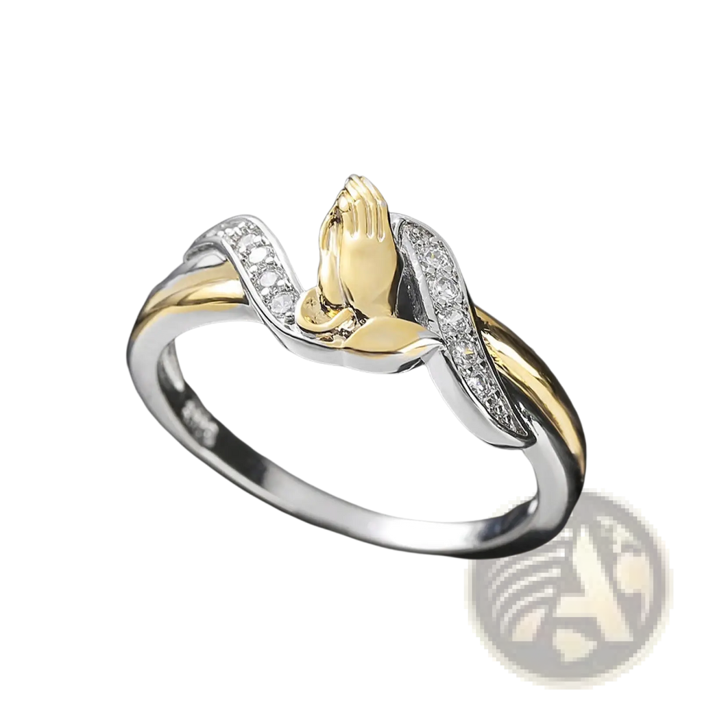 Two tone 18k gold and silver ring with a central praying hands design and clear cubic zirconia stones along bands