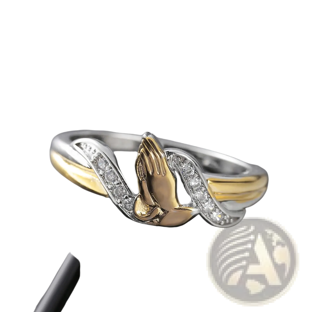Two tone 18k gold praying hands ring with gold and silver band and clear cubic zirconia stones along edges