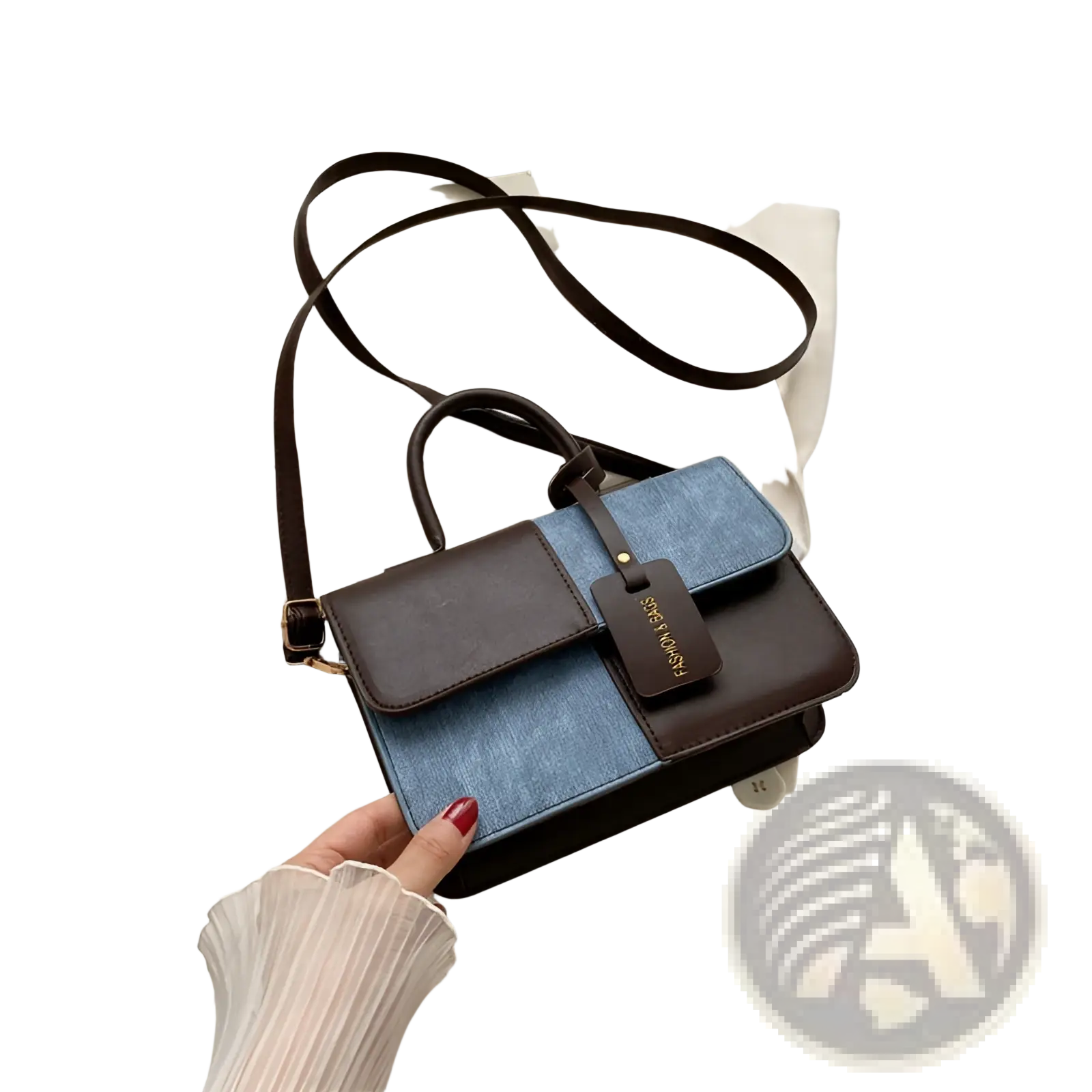 A two tone denim patchwork crossbody bag in denim blue and dark brown leather with an adjustable strap