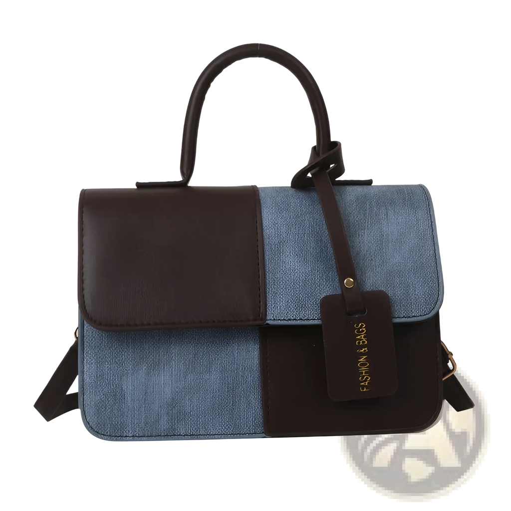 A two tone denim patchwork crossbody bag with dark brown leather and light blue denim featuring matching handles and straps