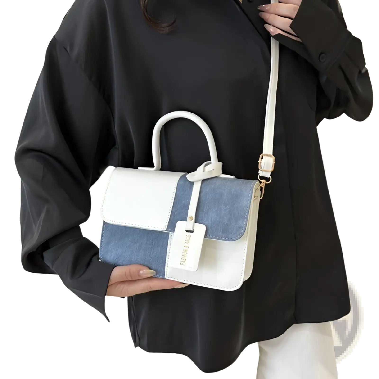 Two tone denim patchwork crossbody bag with white and denim blue panels, structured design, top handle, and gold hardware