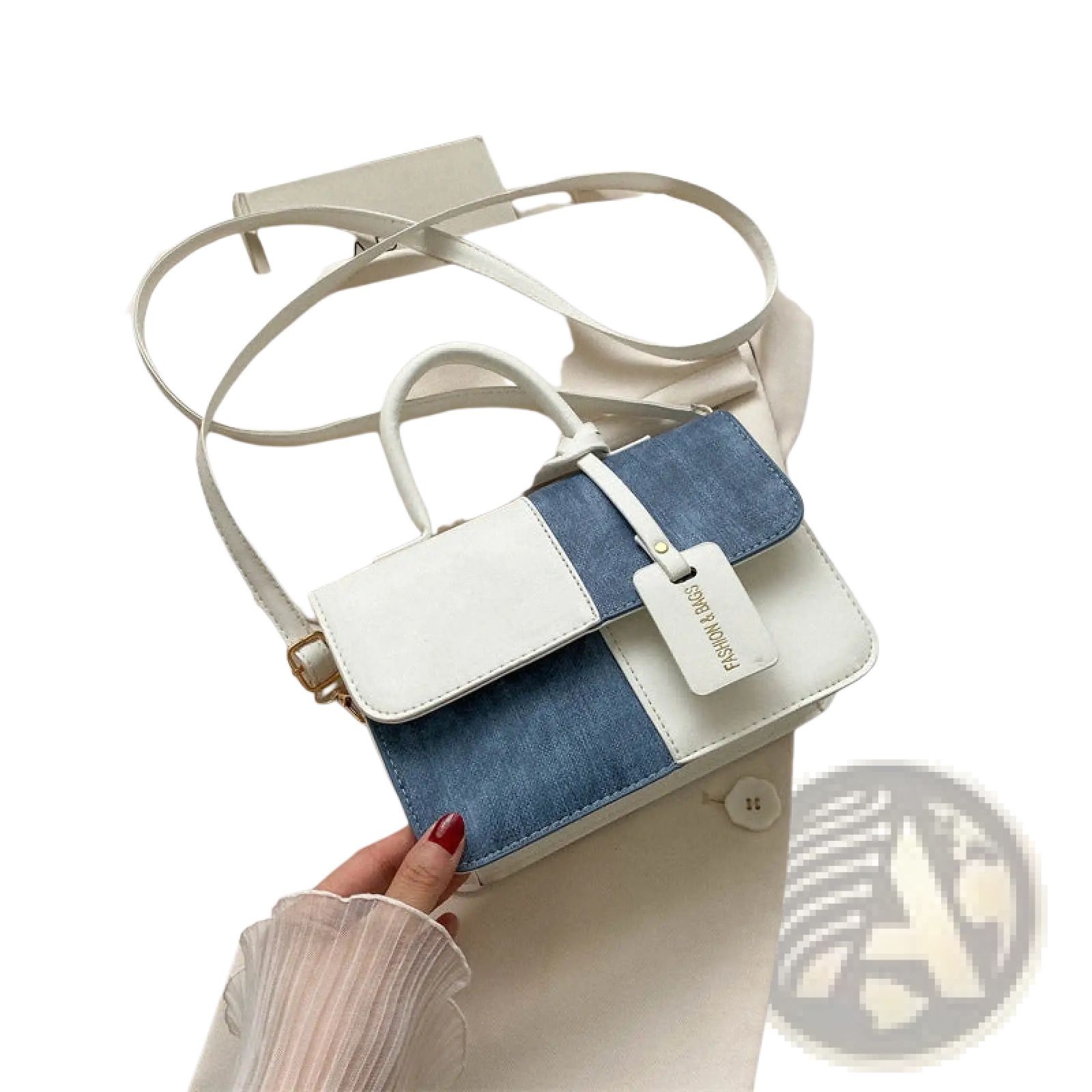 A two tone denim patchwork crossbody bag with a white leather flap, denim panel, and matching white handles and strap