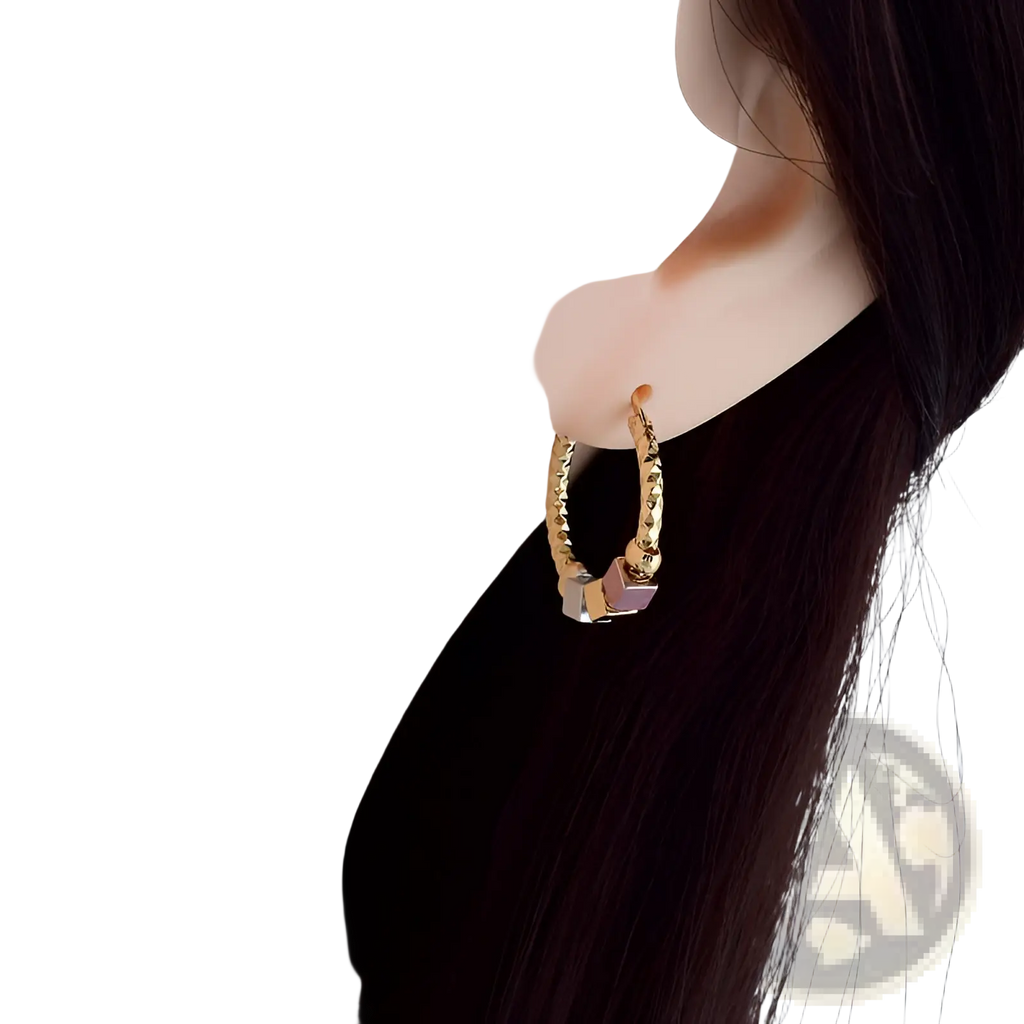 Gold-toned twisted hoop earring with textured design and small rectangular pink gemstone from two tone rose motif collection