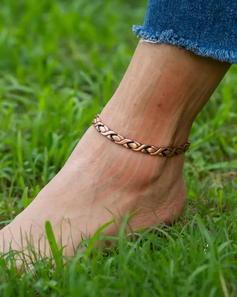 Rose gold pure copper magnetic therapy anklet for women in copper tone with braided woven design worn on ankle