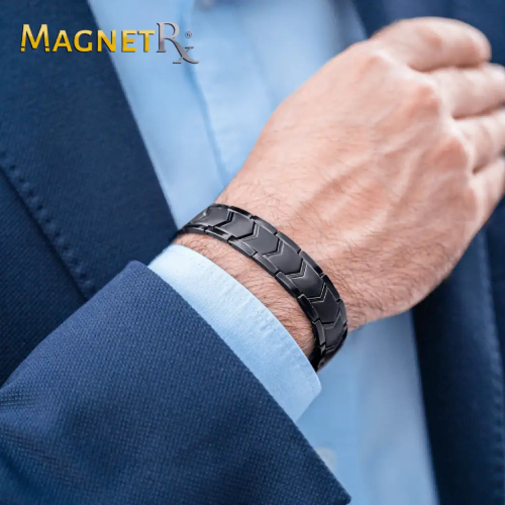 Black ultra strength neodymium magnetic therapy bracelet with sleek interlocking geometric design on a man’s wrist