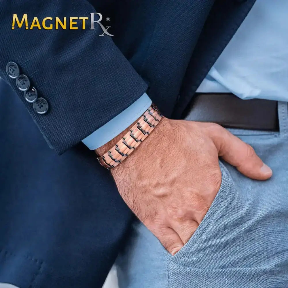 Rose gold pure copper magnetic therapy bracelet with sleek interlocking link design worn on a mans wrist