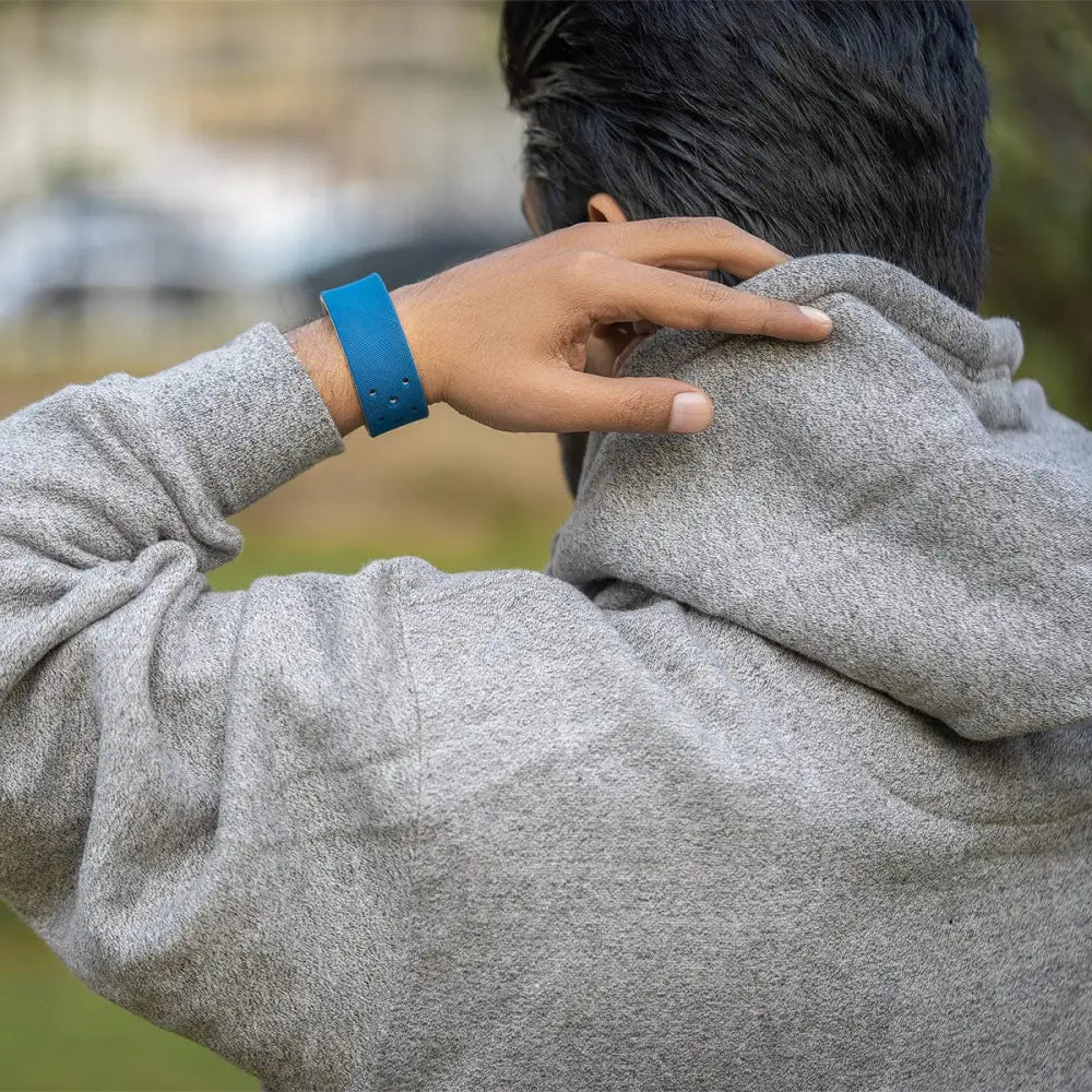 A vibrant blue silicone navy ultra strength magnetic therapy sports bracelet worn on a wrist