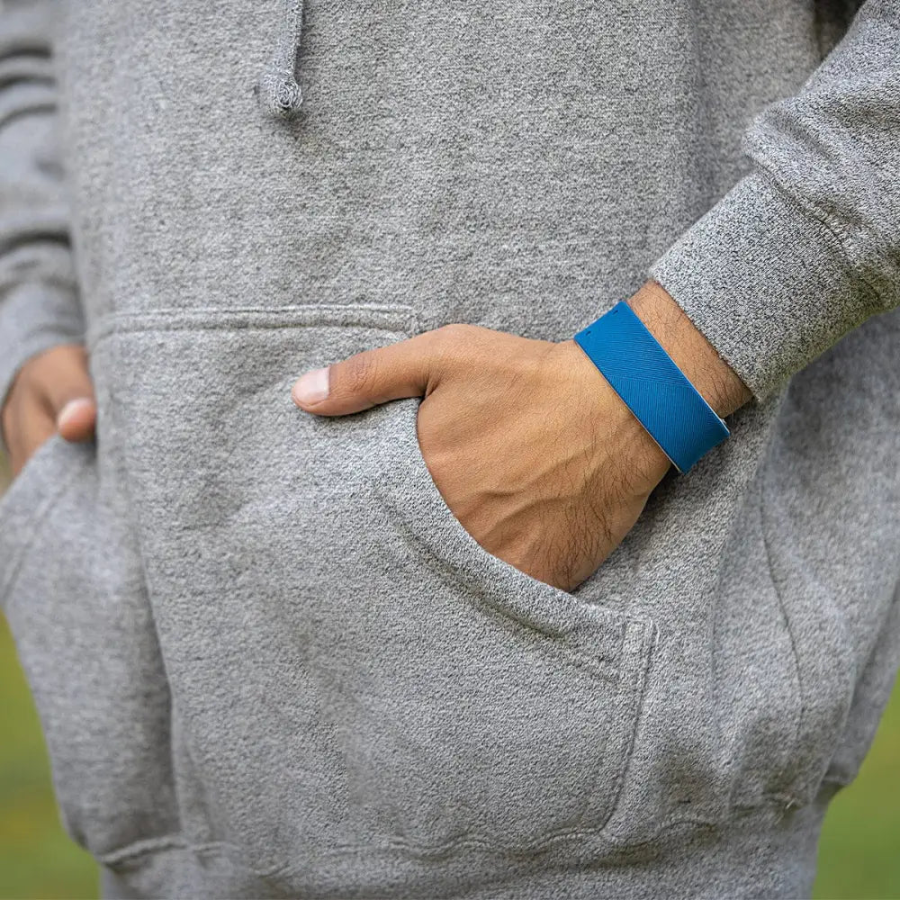 A vibrant blue silicone navy ultra strength magnetic therapy sports bracelet worn on a person’s arm