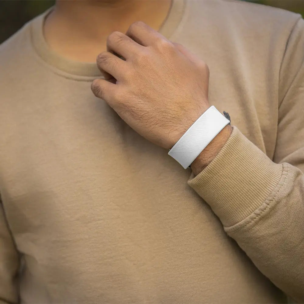 White ultra strength neodymium magnetic sports bracelet with textured band worn on a person’s wrist