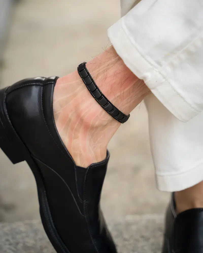 Men’s black titanium magnetic therapy anklet in leather with a segmented textured design