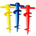 Three brightly colored plastic spiral garden stakes with cross handles for umbrella base use on sand ground and sun beach
