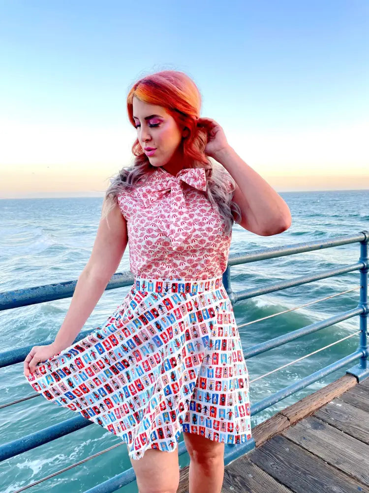 Vintage beach umbrella print bow neckline blouse in pink and white with colorful grid patterned skirt detail