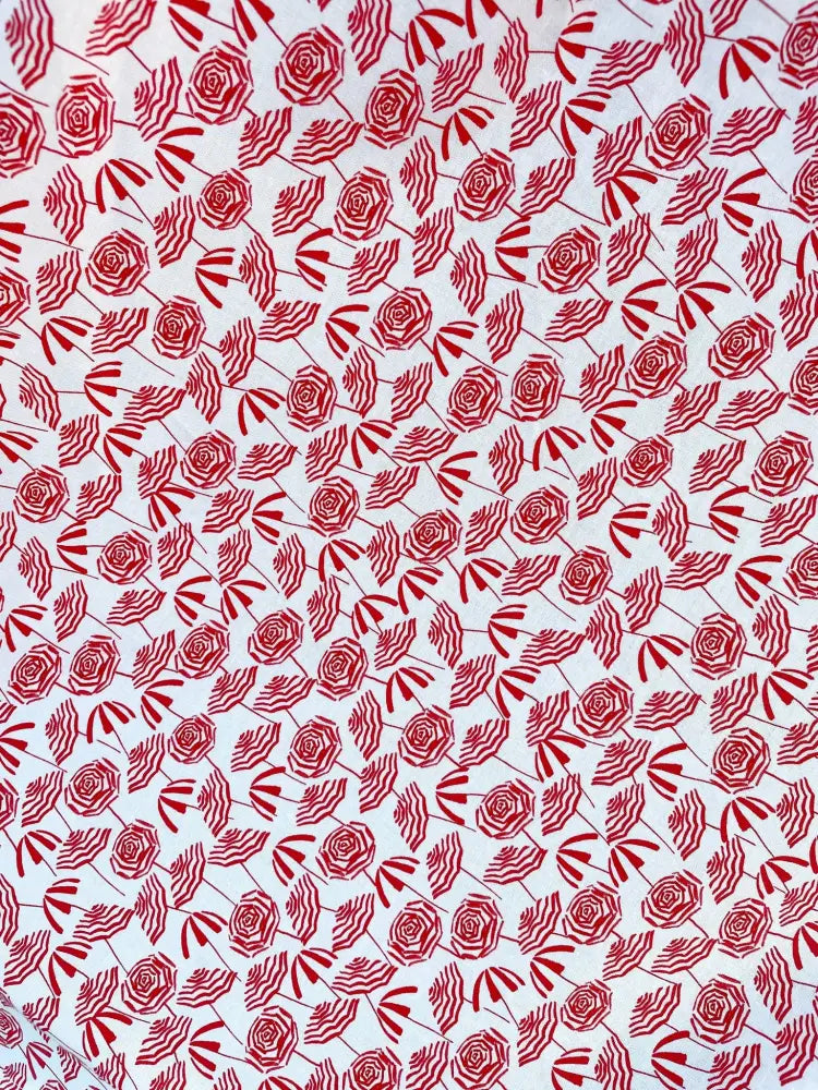 White fabric vintage beach umbrella print bow neckline blouse with repeating red roses and striped umbrellas pattern
