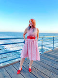 Pink floral print sleeveless vintage umbrella print midi dress with red belt and matching red loafers