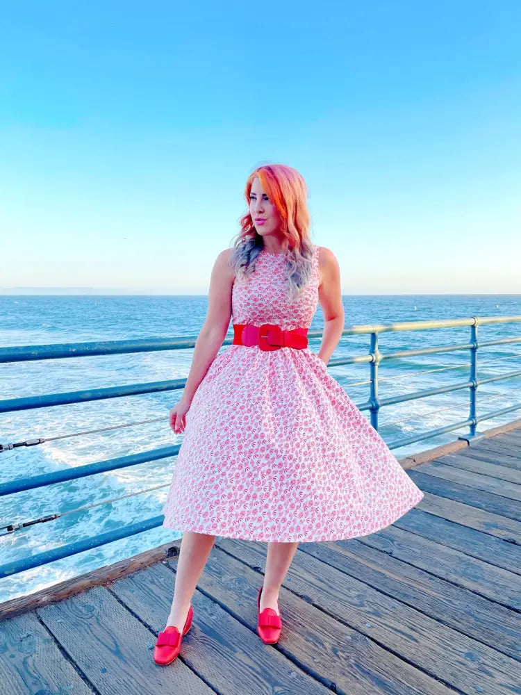 Vintage umbrella print pink floral midi dress with fitted bodice flared skirt and bold red belt detail