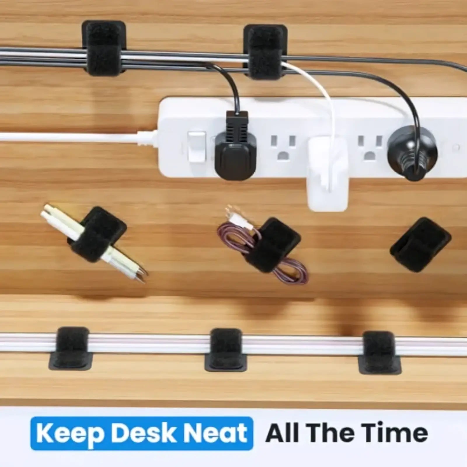 Black velcro cable ties set neatly organizing cords under a wooden desk surface for cable management