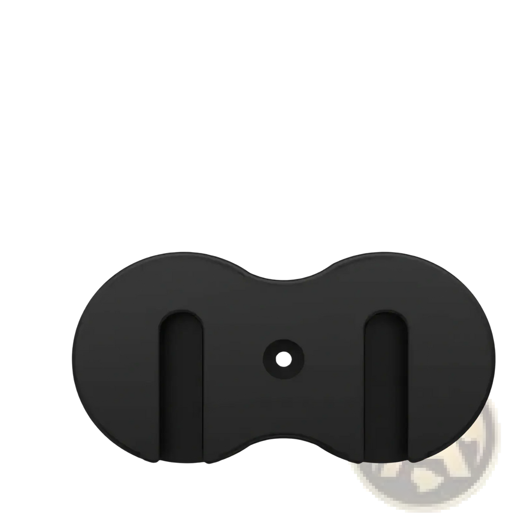 Black oval-shaped under desk game controller mount holder with central hole and vertical slots for secure attachment