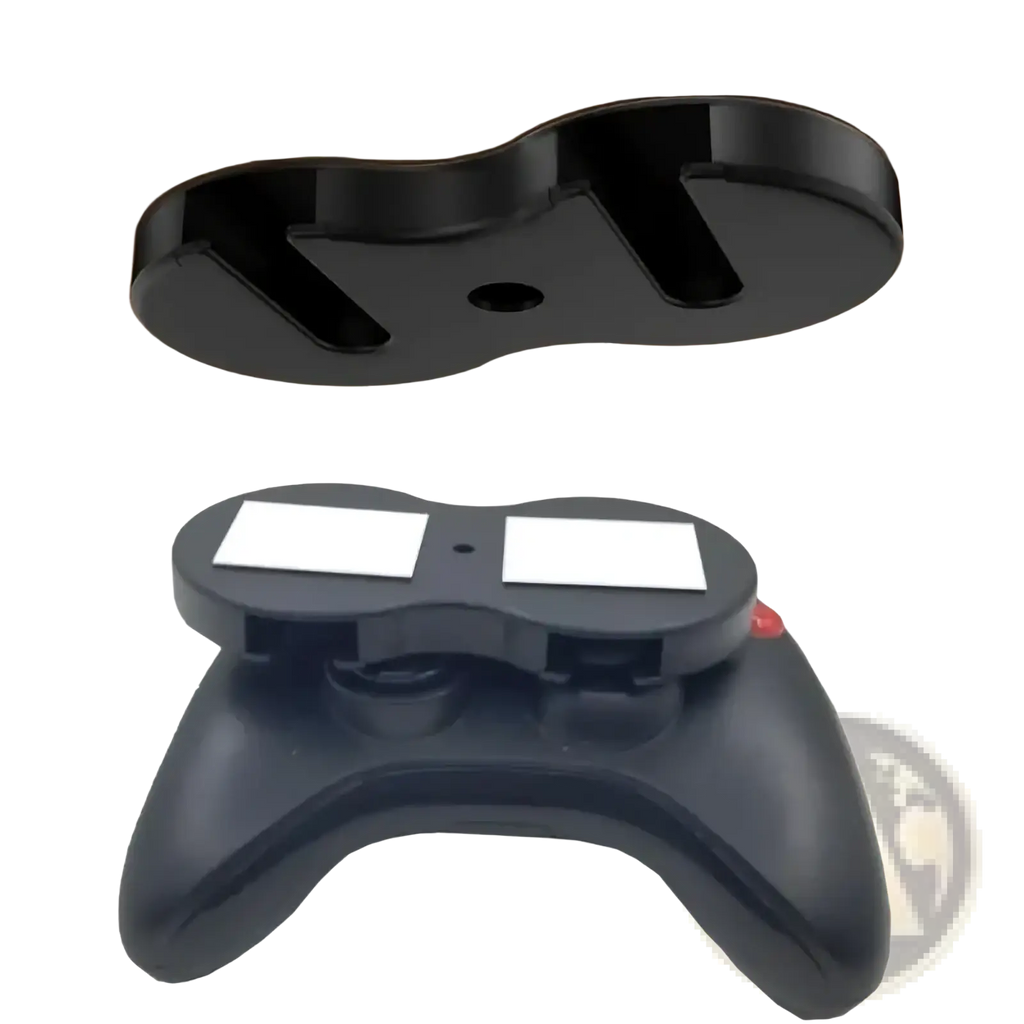 Black plastic under desk game controller mount holder with two white magnetic pads for secure attachment