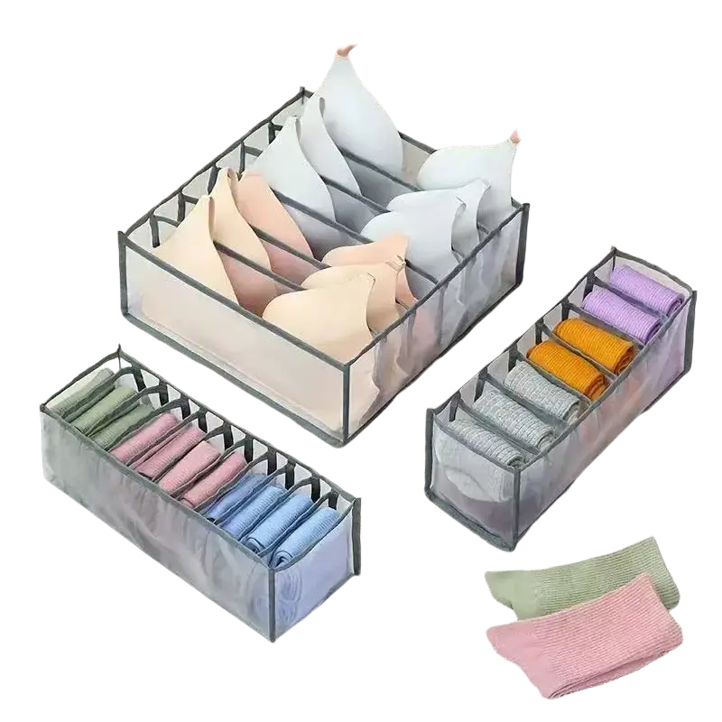 Transparent plastic underwear organizer drawer divider with gray mesh sides black metal frame and multiple compartments
