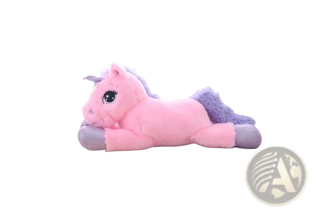 Pink plush unicorn toy with purple mane and tail lying on a couch soft stuffed animal for kids