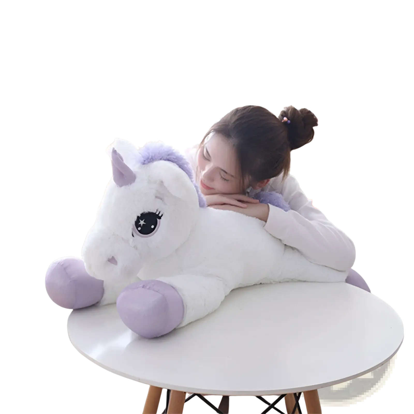 A plush white unicorn toy with lavender accents and large eyes resting on a round table soft pink and purple stuffed animal