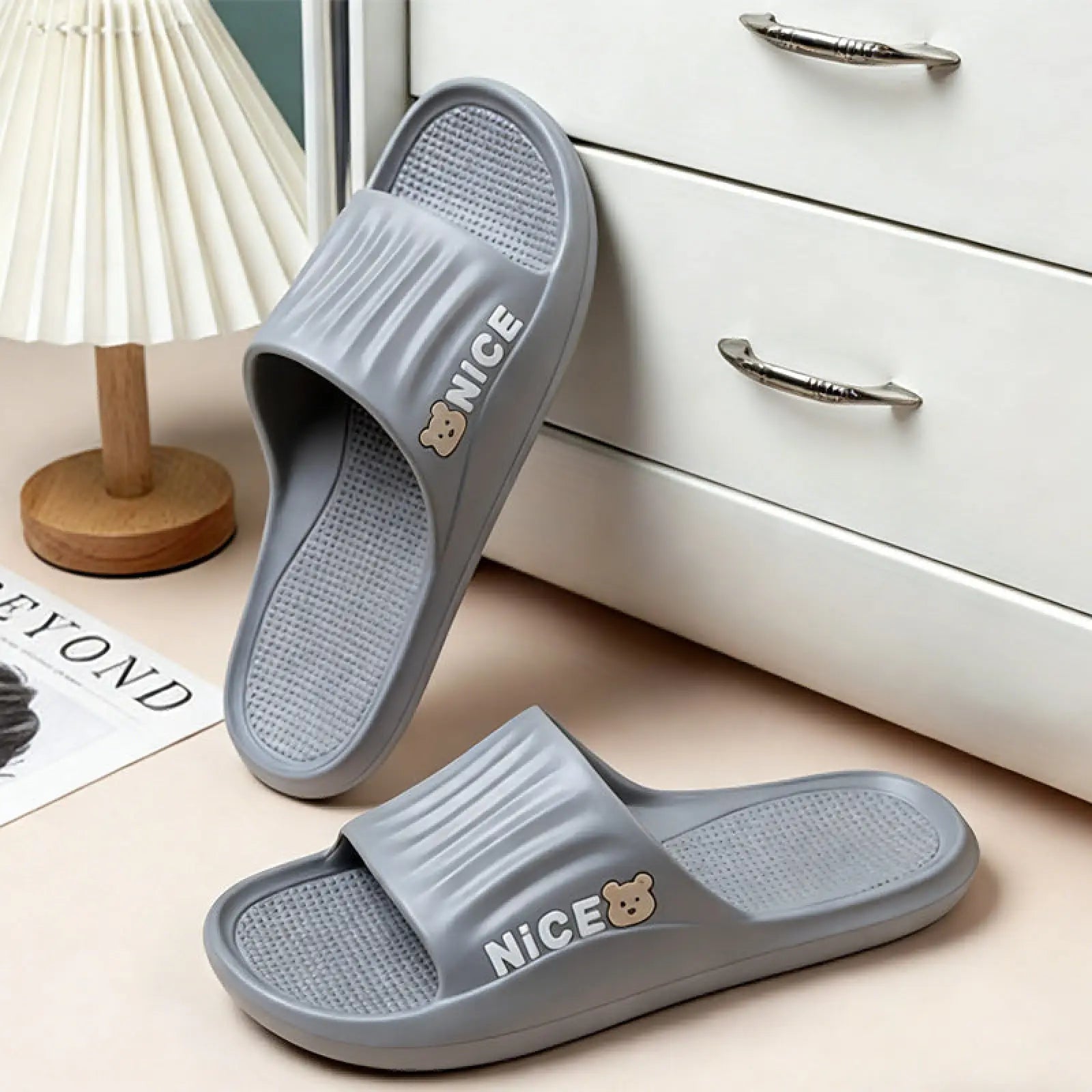 Unisex lightweight gray plastic eva shower slides with anti slip sole and bear logo on the side